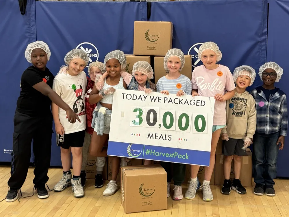 Students packing meals at a school Harvest Pack event
