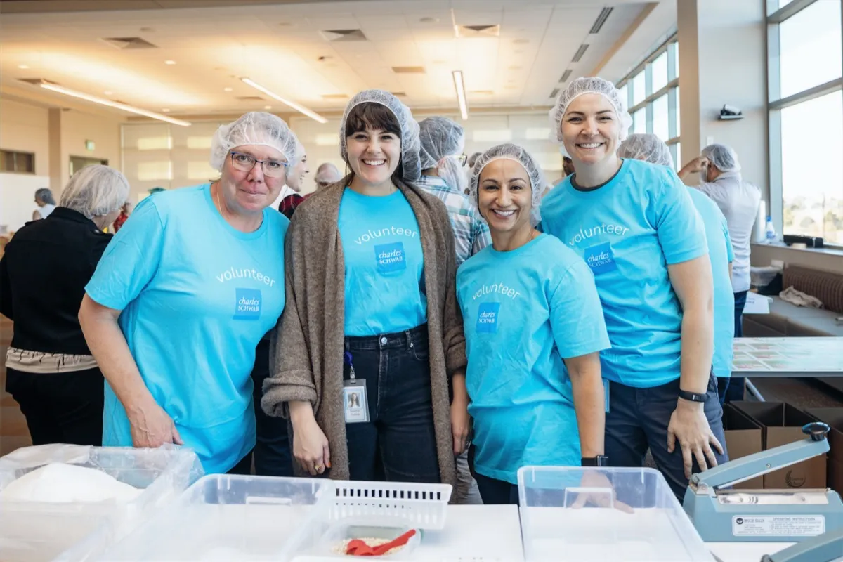 Volunteers smiling together at a Harvest Pack season of giving event